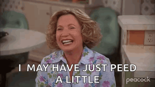 A Woman Is Laughing And Saying `` I May Have Just Peed A Little '' In A Kitchen . GIF