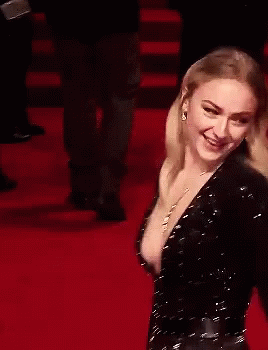 A Woman Is Laughing On A Red Carpet With Her Mouth Open GIF