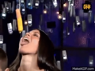 A Woman Is Laughing While Holding A Pencil In Her Mouth . GIF