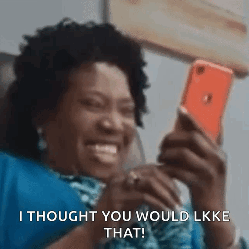 A Woman Is Laughing While Looking At Her Phone And Says I Thought You Would Like That . GIF