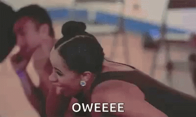 A Woman Is Laughing With A Man In A Gym And The Words Oweee Are On The Screen . GIF