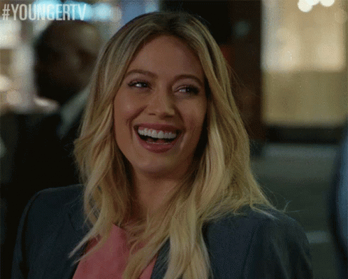 A Woman Is Laughing With A Youngertv Logo In The Corner GIF