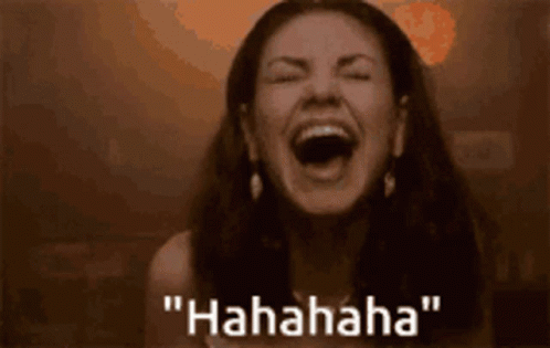 A Woman Is Laughing With Her Mouth Open And The Words " Hahahaha " Written Below Her GIF