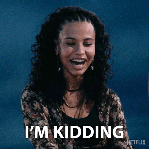A Woman Is Laughing With The Words I 'M Kidding Written Below Her GIF