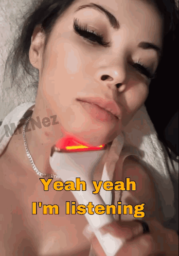 A Woman Is Laying Down With A Device On Her Neck And The Words Yeah Yeah I 'M Listening Above Her GIF
