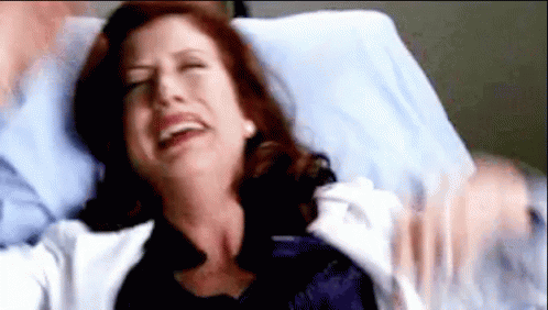 Woman Lying In Hospital Bed With Man Holding Her GIF