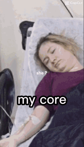 A Woman Is Laying In A Hospital Bed With An Iv In Her Arm And The Words `` She ? My Core '' . GIF