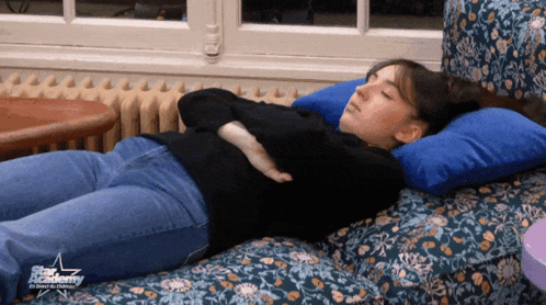Woman Lying On Couch With Star Academy Logo GIF