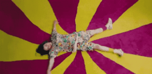 Woman Lying On Colorful Rug GIF