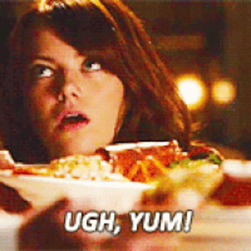 A Woman Is Looking At A Bowl Of Food And Saying Ugh Yum ! GIF