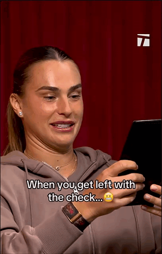 a woman is looking at a cell phone and says when you get left with the check