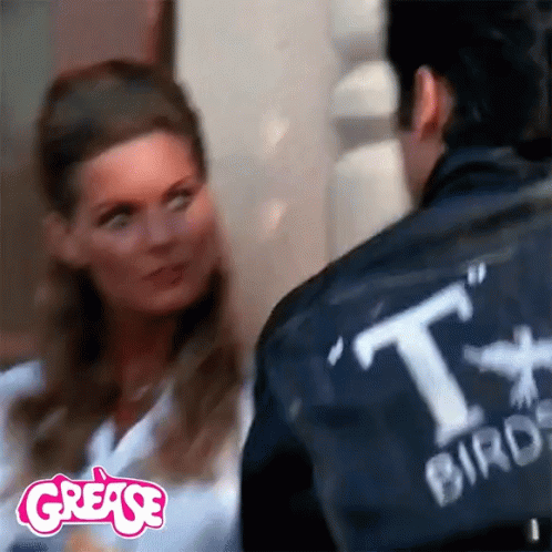A Woman Is Looking At A Man Wearing A Jacket That Says Tx Burger GIF