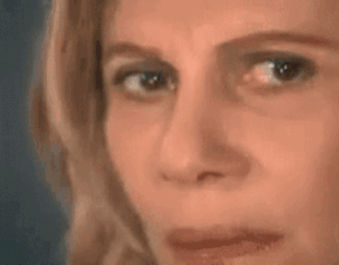 A Woman Is Looking At A Triangle With A Mathematical Equation Written On It . GIF