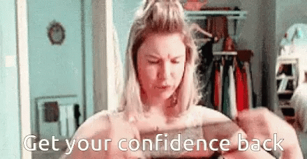 A Woman Is Looking At Herself In A Mirror With The Words " Get Your Confidence Back " Written Below Her . GIF