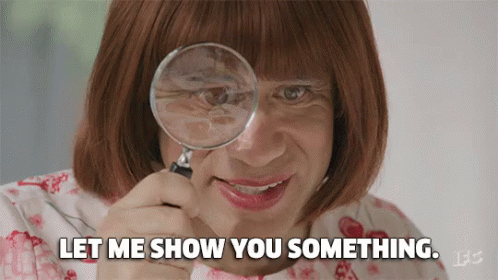 A Woman Is Looking Through A Magnifying Glass And Says Let Me Show You Something GIF