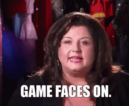 A Woman Is Making A Funny Face And Saying `` Game Faces On '' . GIF