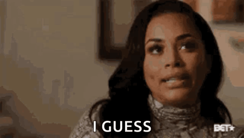A Woman Is Making A Funny Face And Saying `` I Guess '' While Sitting At A Table . GIF