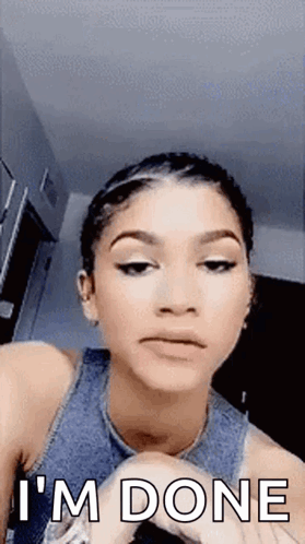 A Woman Is Making A Funny Face And Saying `` I 'M Done '' While Looking At The Camera . GIF