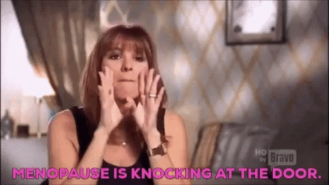 A Woman Is Making A Funny Face And Says `` Menopause Is Knocking At The Door . '' GIF