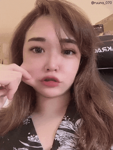 A Woman Is Making A Funny Face In Front Of A Poster That Says " Dark " GIF
