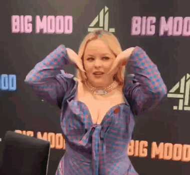 Woman Making Funny Face In Front Of Big Mood Sign GIF