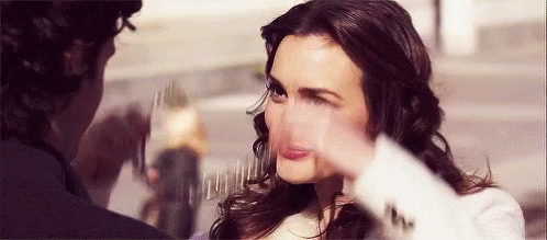 A Woman Is Making A Funny Face While A Man Is Taking A Picture Of Her . GIF