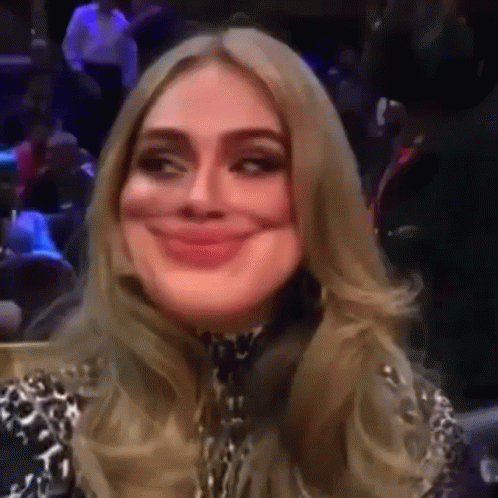 A Woman Is Making A Funny Face While Sitting In A Stadium . GIF