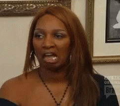 Woman Making Funny Face In Front Of Framed Picture GIF