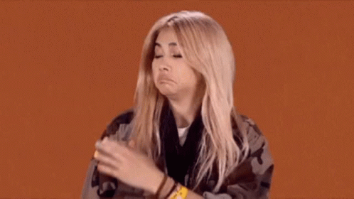 A Woman Is Making A Funny Face While Wearing A Wristband That Says ' A ' On It GIF