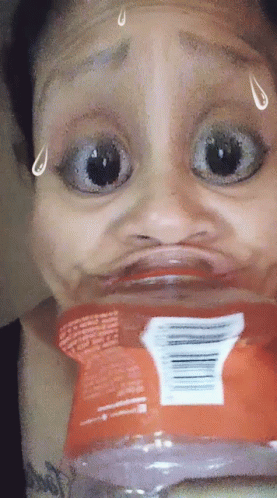 A Woman Is Making A Funny Face With A Bag Of Chips GIF