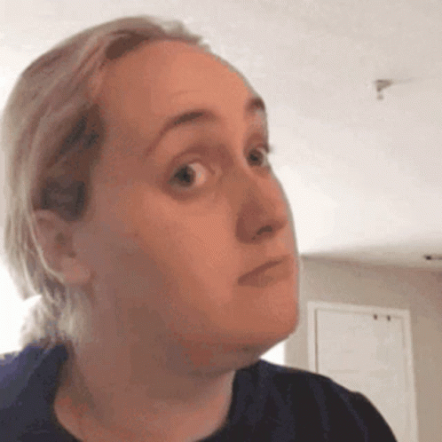 A Woman Is Making A Funny Face With Her Eyes Closed . GIF