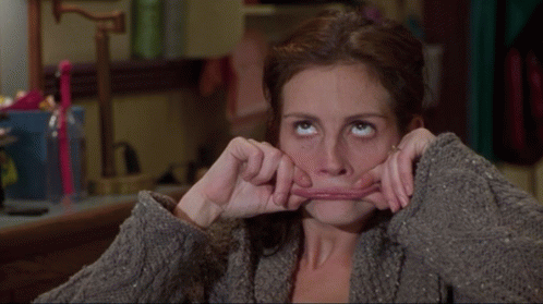 A Woman Is Making A Funny Face With Her Mouth GIF