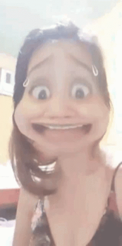 a woman is making a funny face with her mouth open and making a cartoon face .