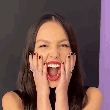A Woman Is Making A Funny Face With Her Mouth Open . GIF