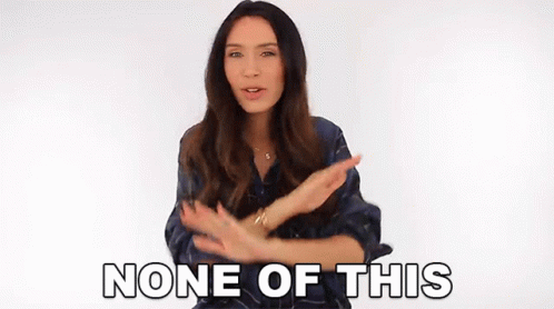 A Woman Is Making A Gesture With Her Hands And The Words None Of This Are Behind Her . GIF