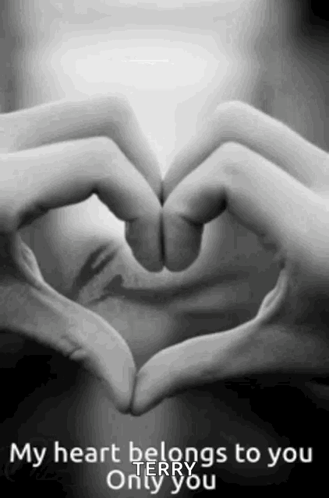 A Woman Is Making A Heart Shape With Her Hands . GIF