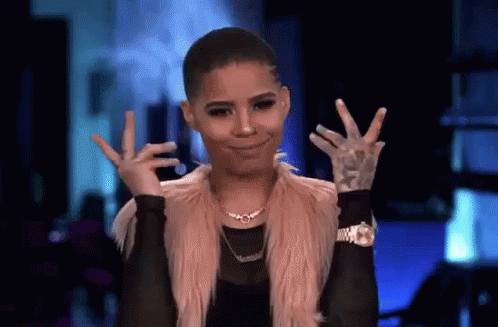 A Woman Is Making A Peace Sign With Her Hands . GIF