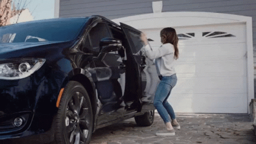 A Woman Is Opening The Door Of A Minivan GIF