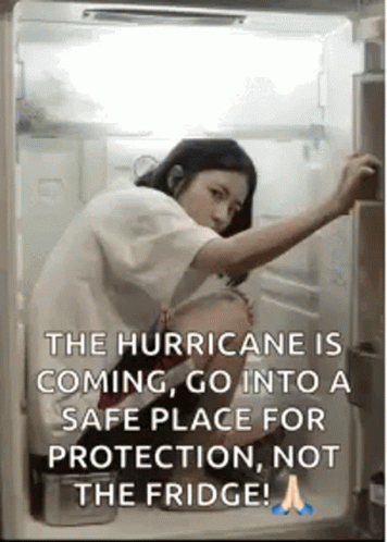 A Woman Is Opening The Door Of A Refrigerator . GIF