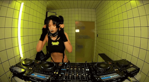 A Woman Is Playing Music On A Pioneer Dj Setup GIF