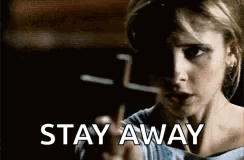 A Woman Is Pointing At The Camera With The Words `` Stay Away '' Written Below Her . GIF