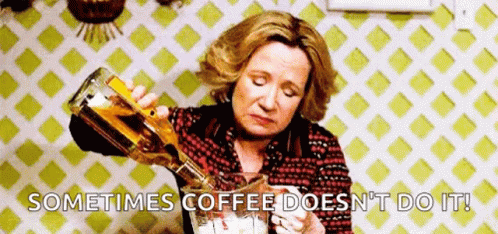 A Woman Is Pouring A Bottle Of Alcohol Into A Glass . GIF