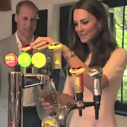 A Woman Is Pouring A Drink From A Tap That Says " Stella " On It GIF