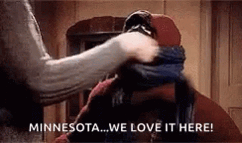 A Woman Is Putting A Scarf Around A Man 'S Face . GIF