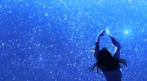 A Woman Is Reaching Up Towards A Star In The Sky GIF