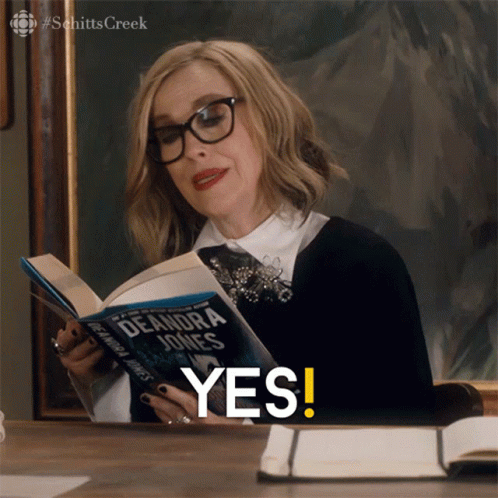 A Woman Is Reading A Book By Deandra Jones GIF