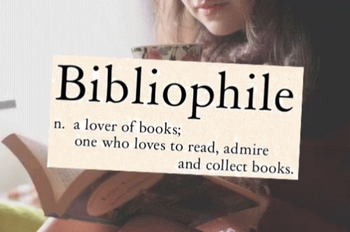 A Woman Is Reading A Book While Holding A Sign That Says Bibliophile GIF