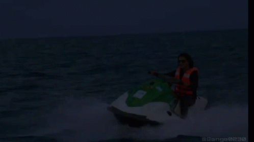 A Woman Is Riding A Jet Ski In The Ocean With The Words On My Way Written Below Her GIF