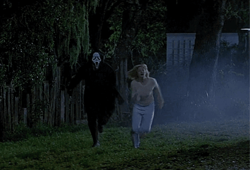 A Woman Is Running Away From A Man With A Scream Mask On His Face GIF