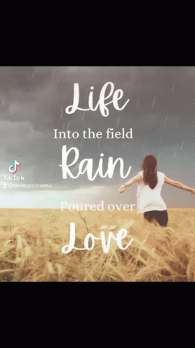 A Woman Is Running Through A Field With The Words Life Into The Field Rain Poured Over Love Written Above Her GIF